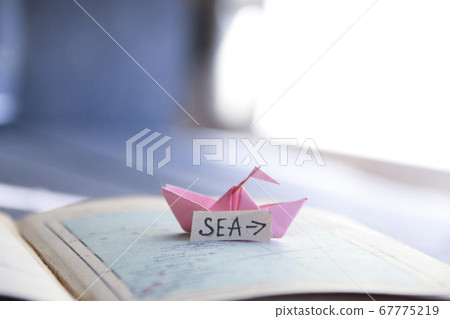 Sea idea. Paper boat on the map and inscription. Sea idea. Paper boat on the map and inscription. 67775219