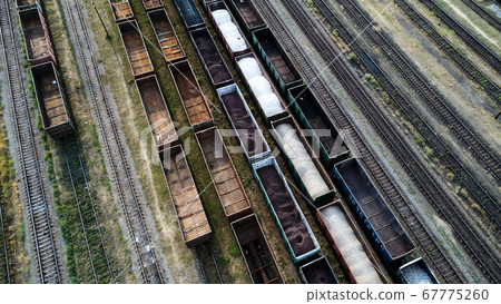 Aerial view of rail sorting freight station with railway cars, with many rail tracks railroad. Heavy industry landscape. 67775260