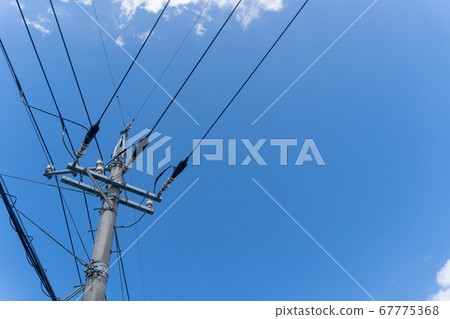 Telephone pole under blue sky Telephone pole under blue sky 67775368