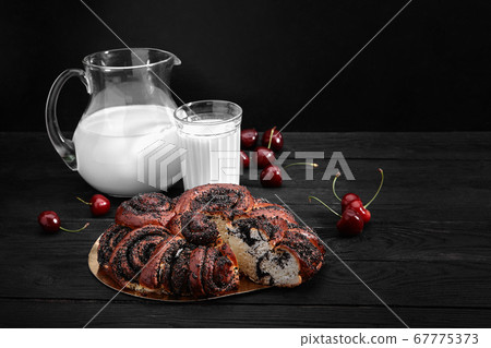 Homemade roll with poppy seeds and milk for breakfast 67775373