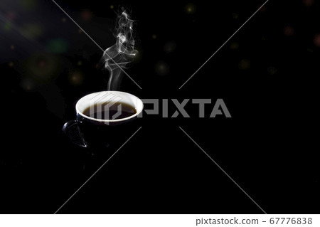 Black coffee in a dark glass on a black background Black coffee in a dark glass on a black background 67776838