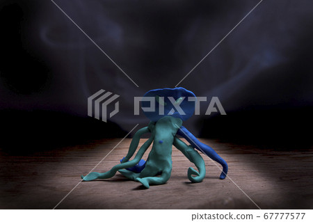 Plasticine Monster Receive Halloween Placed on a wooden floor with a backdrop of black floating smoke. 67777577