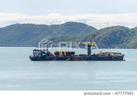 Offshore Barges with crane and Platform Supply Vessel mooring near island 67777985