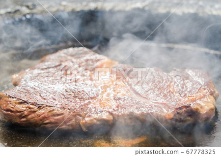 Grilled beef and Angus beef shoulder loin steak on an iron plate 67778325