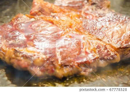 Grilled beef and Angus beef shoulder loin steak on an iron plate Grilled beef and Angus beef shoulder loin steak on an iron plate 67778328