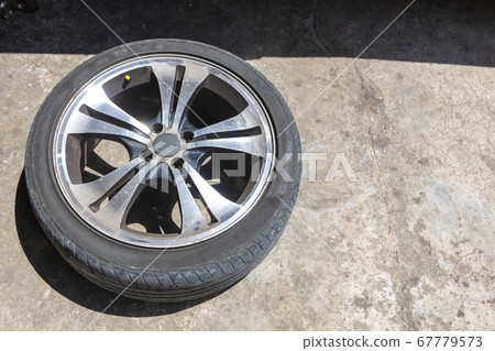 One car wheel with tyre on ground 67779573