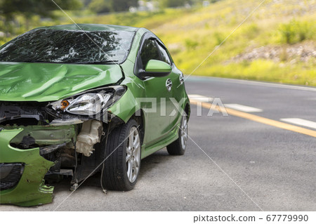 Front of green color car damaged and broken by 67779990