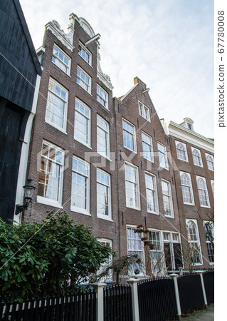 Amsterdam cityscape, Holland Lawn square and elongated brick houses 67780008