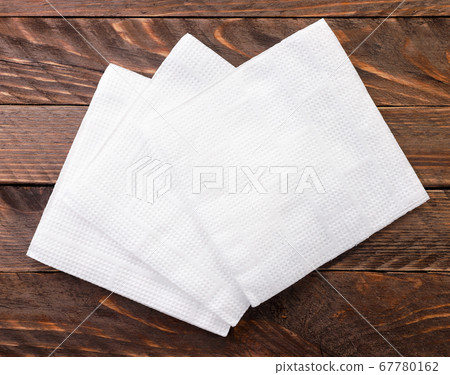 White paper napkins on wooden background. The view 67780162