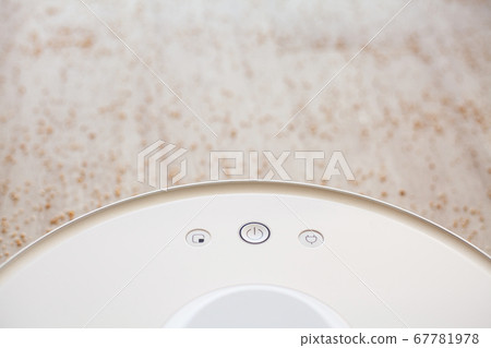 Smart House. Vacuum cleaner robot runs on wood floor in a living room Smart House. Vacuum cleaner robot runs on wood floor in a living room 67781978