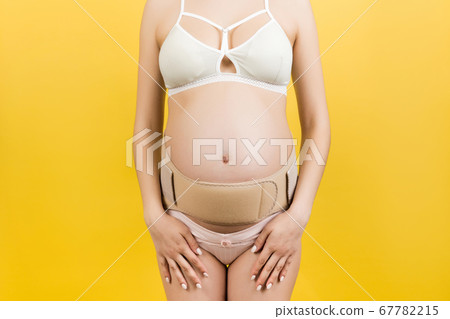 Close up of pregnant woman in underwear with Close up of pregnant woman in underwear with 67782215