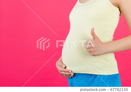 Cropped shot of positive pregnant woman in Cropped shot of positive pregnant woman in 67782230