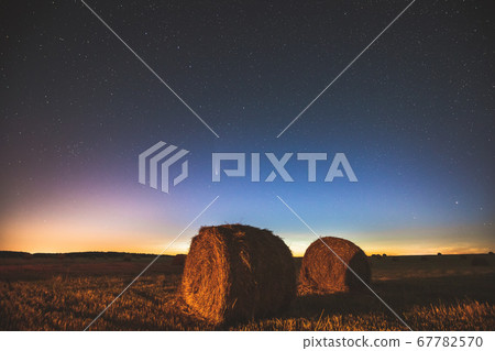 Comet Neowise C2020 F3 In Night Starry Sky Above Haystacks In Summer Agricultural Field. Night Stars Above Rural Landscape With Hay Bales After Harvest. Agricultural Concept 67782570