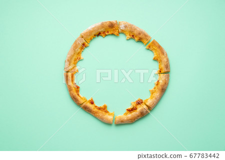 Pizza crust only isolated on a green background. Pizza crust only isolated on a green background. 67783442