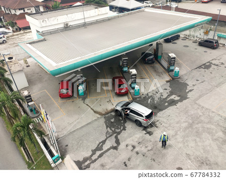 Petronas petrol station during the daytime. Customers come to visit this petrol station to refuel, buy groceries or use the facilities provided. Petronas petrol station during the daytime. Customers come to visit this petrol station to refuel, buy groceries or use the facilities provided. 67784332
