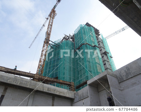 SEREMBAN, MALAYSIA -MARCH 7, 2020: Steel reinforced concrete structure is built at the construction site. Built using formworks made of wood and plywood. Manually build by the workers. SEREMBAN, MALAYSIA -MARCH 7, 2020: Steel reinforced concrete structure is built at the construction site. Built using formworks made of wood and plywood. Manually build by the workers. 67784486