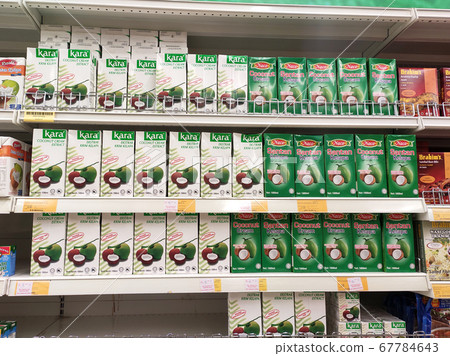 KUALA LUMPUR, MALAYSIA -JUNE 4, 2020: Processed coconut milk packed in the small commercial paper box and displayed for sale on a steel rack inside the supermarket. Sorted by brand. KUALA LUMPUR, MALAYSIA -JUNE 4, 2020: Processed coconut milk packed in the small commercial paper box and displayed for sale on a steel rack inside the supermarket. Sorted by brand. 67784643