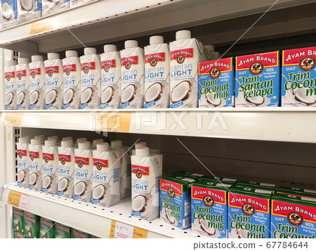 KUALA LUMPUR, MALAYSIA -JUNE 4, 2020: Processed coconut milk packed in the small commercial paper box and displayed for sale on a steel rack inside the supermarket. Sorted by brand. KUALA LUMPUR, MALAYSIA -JUNE 4, 2020: Processed coconut milk packed in the small commercial paper box and displayed for sale on a steel rack inside the supermarket. Sorted by brand. 67784644