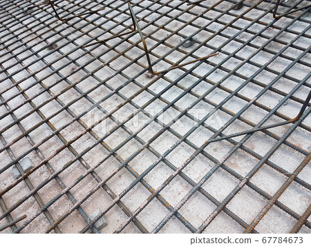KUALA LUMPUR, MALAYSIA -MARCH 3, 2020: Building floor slab under construction. Construction workers fabricating the timber formwork and installing the steel reinforcement bar. KUALA LUMPUR, MALAYSIA -MARCH 3, 2020: Building floor slab under construction. Construction workers fabricating the timber formwork and installing the steel reinforcement bar. 67784673
