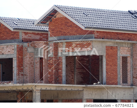 SEREMBAN, MALAYSIA -APRIL 07, 2020: New double story luxury terrace house under construction in Malaysia.  Designed by an architect with a modern and contemporary style.  67784821
