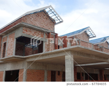 SEREMBAN, MALAYSIA -APRIL 07, 2020: New double story luxury terrace house under construction in Malaysia.  Designed by an architect with a modern and contemporary style.  67784835