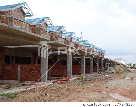 SEREMBAN, MALAYSIA -APRIL 07, 2020: New double story luxury terrace house under construction in Malaysia.  Designed by an architect with a modern and contemporary style.  67784836