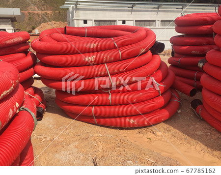 SEREMBAN, MALAYSIA -APRIL 06, 2019: HDPE corrugated pipe stored in open space at the construction site. It is used as conduit to protect underground electrical and telecommunication cable.  67785162