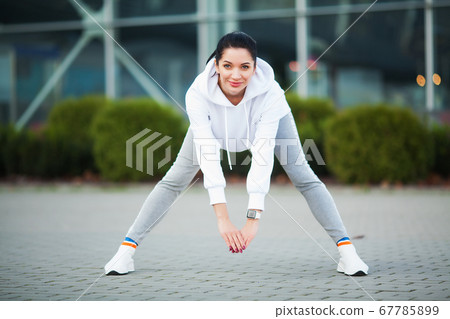 Woman Stretching Body, Doing Exercises On Street. 67785899