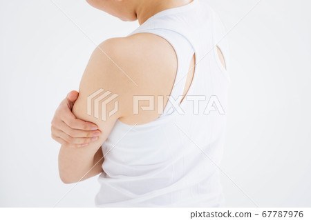 A woman touching his lower arm 67787976