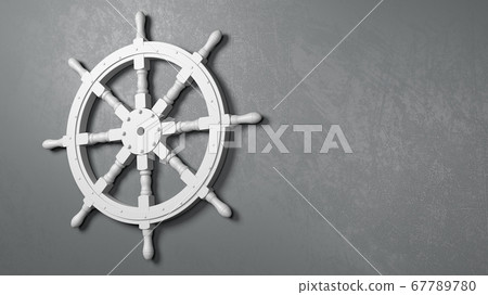 Boat Rudder Wheel Against a Gray Wall 67789780