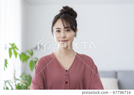 Young woman wearing wireless earphones 67796716