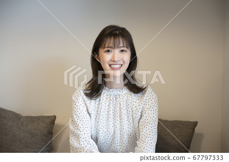 A young woman looking at the camera A young woman looking at the camera 67797333