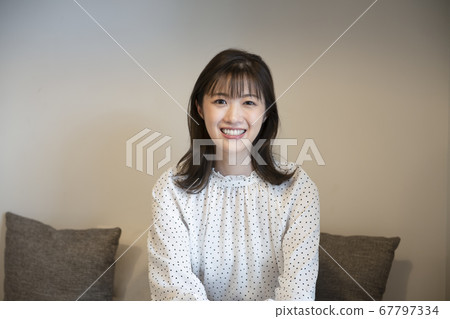 A young woman looking at the camera 67797334