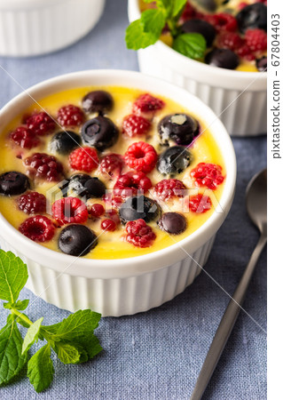 Clafoutis made from white yogurt and berries 67804403