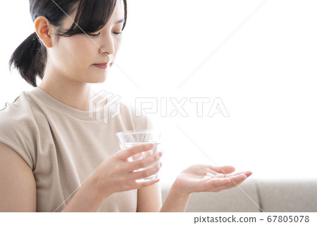 Woman taking medicine Woman taking medicine 67805078