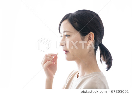 Woman taking medicine Woman taking medicine 67805091