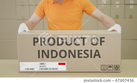 PRODUCT OF INDONESIA printed text on the side of a big cardboard box in a warehouse PRODUCT OF INDONESIA printed text on the side of a big cardboard box in a warehouse 67807436