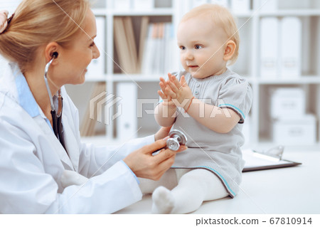 Doctor and patient in hospital. Little girl is being examined by doctor with stethoscope. Medicine concept 67810914