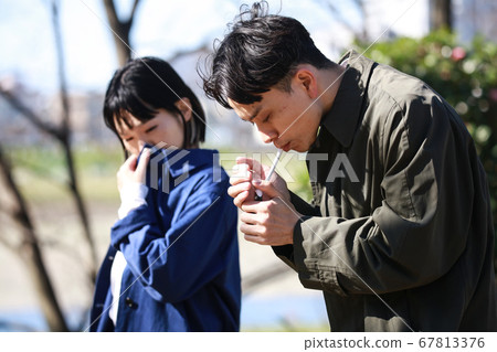 Men smoking and hating cigarettes 67813376