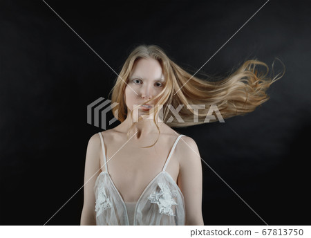 Conceptual portrait of a young blonde girl with 67813750