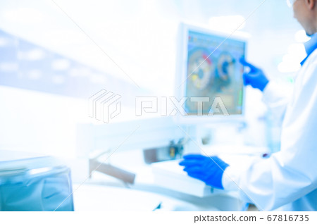 Laboratory assistant in rubber gloves working with 67816735