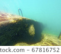 Concrete block under water. Reflection of sun rays under water on a stone. 67816752