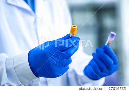 Hands in rubber gloves hold test tubes. Hands in rubber gloves hold test tubes. 67816785