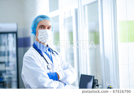 A doctor in a protective mask with a phonendoscope 67816790