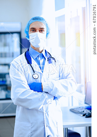 A doctor in a protective mask with a phonendoscope A doctor in a protective mask with a phonendoscope 67816791