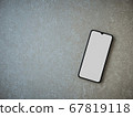 Black mobile smartphone mockup lies on the surface 67819118