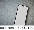 Black mobile smartphone mockup lies on the surface 67819120