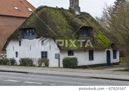 old apartment building, thatched roof. Housing in Europe 67820167