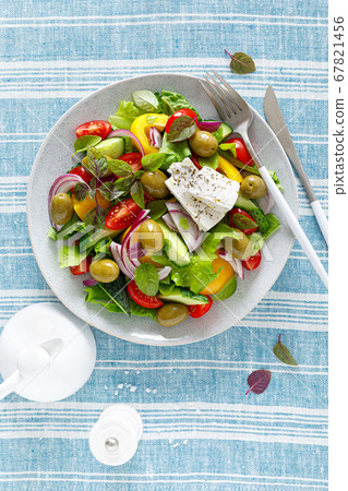 Greek salad. Fresh vegetable salad of cucumbers, 67821456