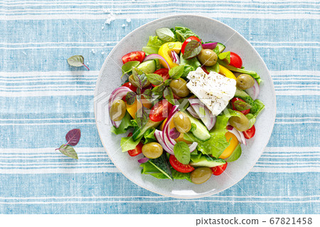 Greek salad. Fresh vegetable salad of cucumbers, 67821458